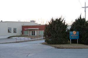 Exterior of the Magnolia Metal Corporation facility with the Magnolia Metal sign at the entrance.